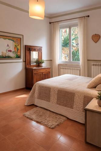 a bedroom with a large bed and a window at Desiree Holiday Inn in Le Grazie