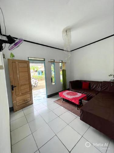 a living room with a couch and a table at Tiga Dara Homestay 3 in Pangandaran