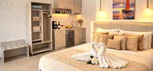 a bedroom with a white bed with a swan on it at Knossos Sunrise in Palekastron