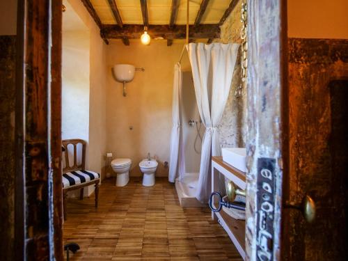 a bathroom with a toilet and a sink and a shower at Red Palazzo Fossanova in Priverno
