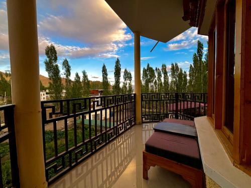 a balcony with a bench and a view at Zaltak Guest House and Hostel in Leh