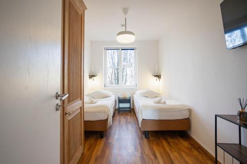 a room with two beds and a window at Central Station Apartment in Dessau