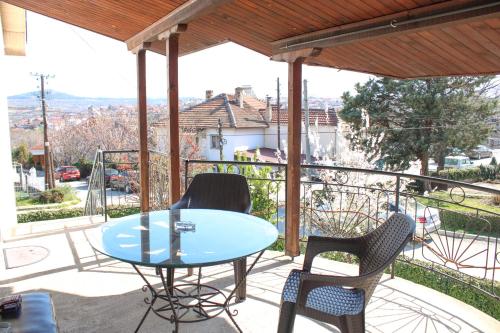 a patio with a table and chairs on a balcony at House Stoevi in Negotino