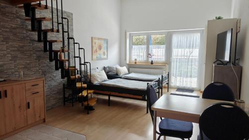 a living room with a couch and a spiral staircase at Kurpension Meßmer in Tengen