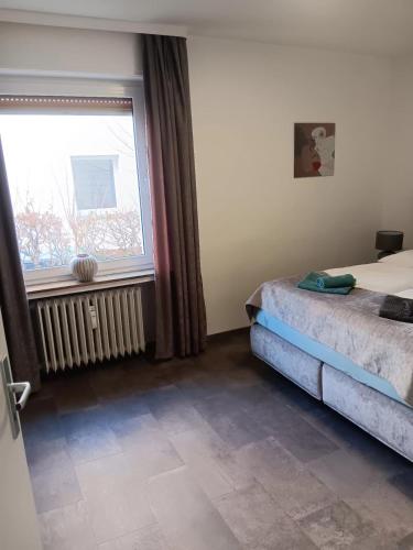 a bedroom with a bed and a large window at Kontinental A in Bad Harzburg