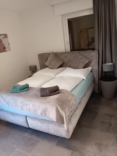 a bed with two pillows on it in a room at Kontinental A in Bad Harzburg