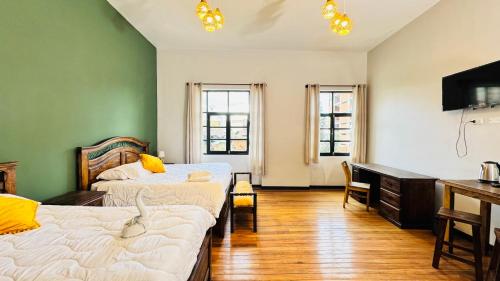 a room with two beds and a desk in it at 1825 Hotel in La Paz