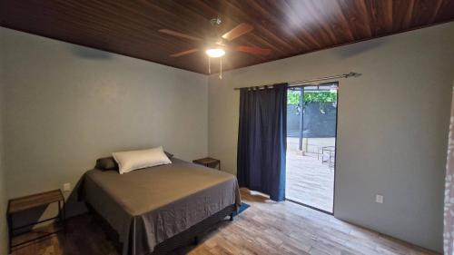a bedroom with a bed and a sliding glass door at House with a private pool in Ojochal
