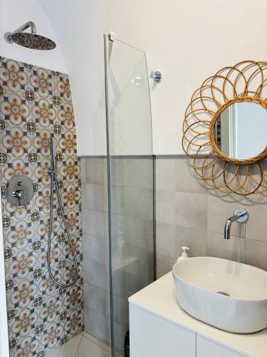 a bathroom with a sink and a shower at Affittacamere Nalì in Polignano a Mare