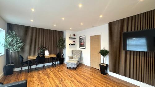 a living room with a desk and a table with a chair at Modern 2 Bedroom Apartment near Crosby Beach & Liverpool in Crosby