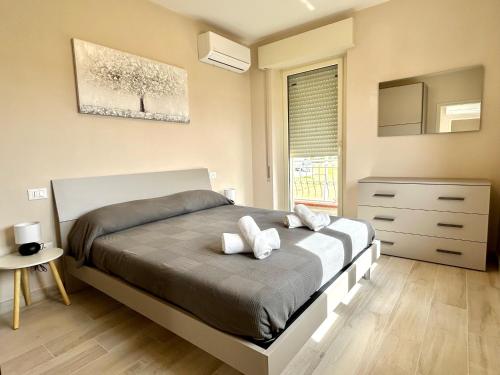 a bedroom with a bed and a dresser and a window at Villa La Palma in Camaiore