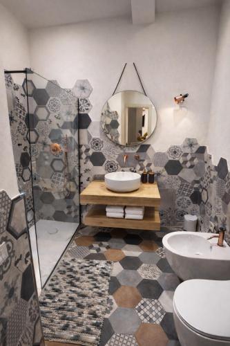 a bathroom with a sink and a mirror at Molo di Alassio Luxury Room in Alassio