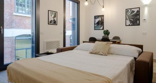 a bedroom with a large bed and a large window at Modern Apartment between Como & Milan in Lomazzo