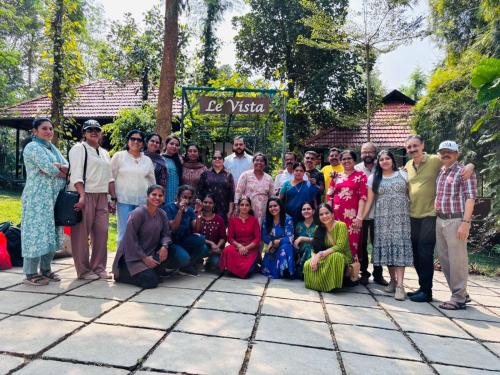 a large group of people posing for a picture at Le Vista Resort in Sultan Bathery