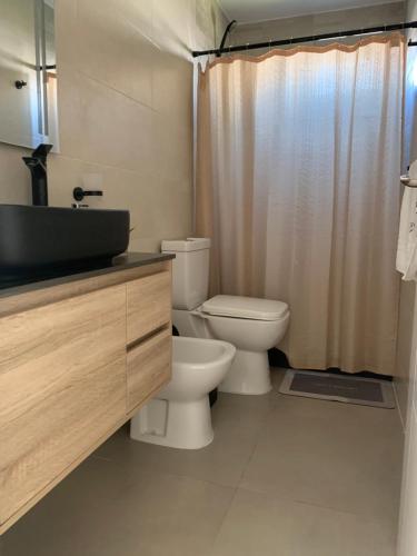 a bathroom with a toilet and a sink and a shower at Casa 6 personas con piscina en Piriápolis Playa los Angeles in Piriápolis