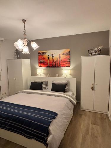 a bedroom with a bed with a painting on the wall at Bel apartment - Waterloo in Waterloo