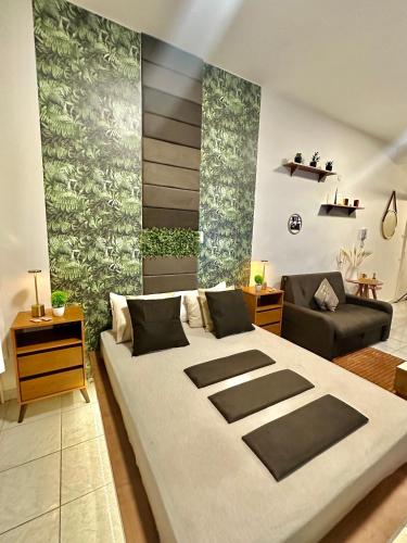 a bedroom with a large bed and a couch at Copacabana, Design Elegante A 100m Do Mar in Rio de Janeiro