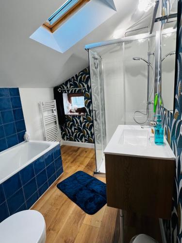 a bathroom with a tub and a sink and a toilet at Maison de charme du 18 e s de centre ville in Sablé-sur-Sarthe