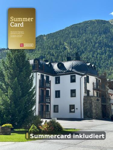 a large white building with a sign in front of it at Alpenfels Apartments - Zwieselstein in Sölden