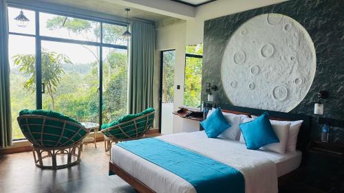 a bedroom with a bed and chairs and a large window at Fern Hill Cabins in Ella