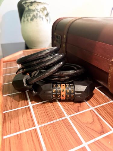 a pile of cords sitting on a table next to a suitcase at Baan Lek Tee 6 - 9Chinatown near Yaowarat and MRT in Bangkok