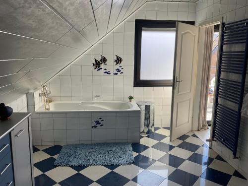 a bathroom with a tub and a window at Emma in Oberhausen