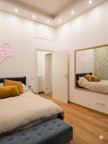 a bedroom with two beds and a mirror on the wall at Equi60 in Rome