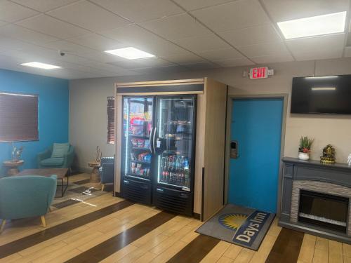 a waiting room with a drink cooler and a fireplace at Days Inn by Wyndham Fredericksburg North in Fredericksburg
