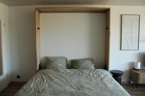 a bedroom with a bed with a wooden frame at Studio Avondzon in Blankenberge