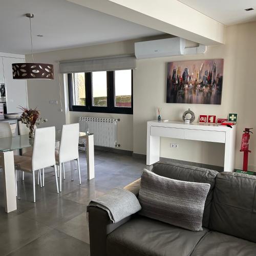 a living room with a couch and a table at Casa da Fonte, Monte in Terras de Bouro