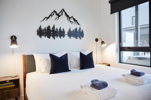 a bedroom with a bed with a mountain mural on the wall at Ripper Retreat in Revelstoke
