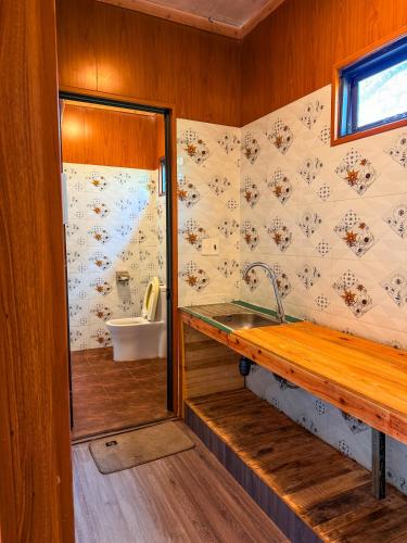 a bathroom with a sink and a toilet in it at Bungalow Scent in Da Lat