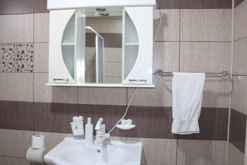 a bathroom with a sink and a mirror at Corner Five in Negotino