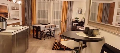 a kitchen and living room with a table and chairs at Magnifique Loft 65m en Open Space in Paris