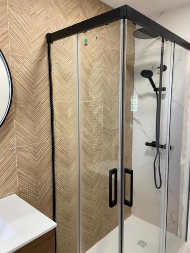 a shower with a glass door in a bathroom at Casa Ares in Cee