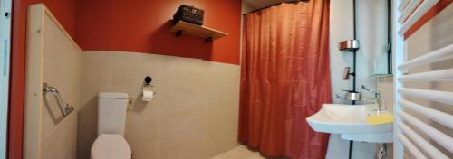 a bathroom with a toilet and a sink at Ty Véron, labellisé PMR in Asnières-la-Giraud