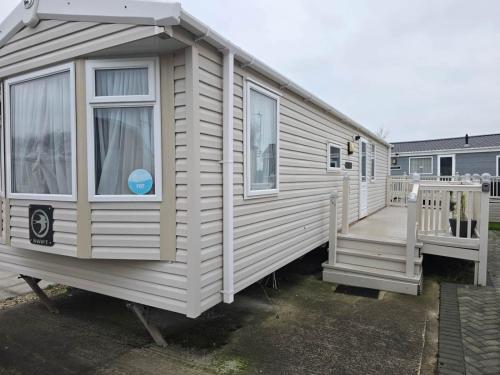a small house with a porch and a staircase at Towyn Winkups F07 in Rowen