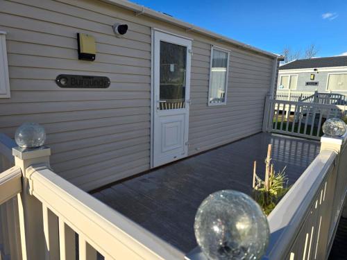 a deck with a door on a house at Towyn Winkups F07 in Rowen
