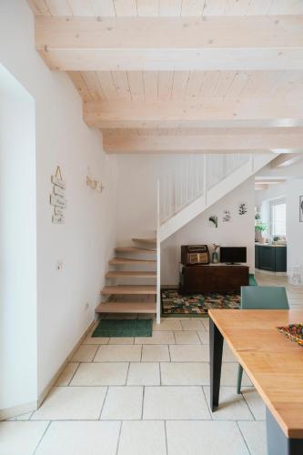 a staircase in a living room with white walls at Il Conventino 46 in Falconara Marittima