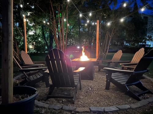 a group of chairs around a fire pit at night at Fall Family Getaway in PFGtlnbg Nr Dollywood Hot Tub, Fire Pit, Cable in Pigeon Forge