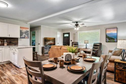 a kitchen and living room with a table and chairs at Fall Family Getaway in PFGtlnbg Nr Dollywood Hot Tub, Fire Pit, Cable in Pigeon Forge