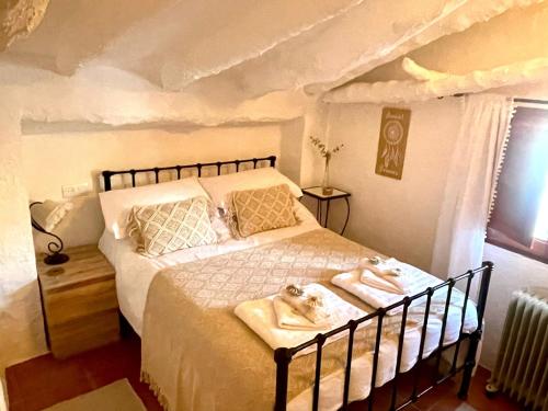 a bedroom with a bed with two towels on it at Las Parras in Rute