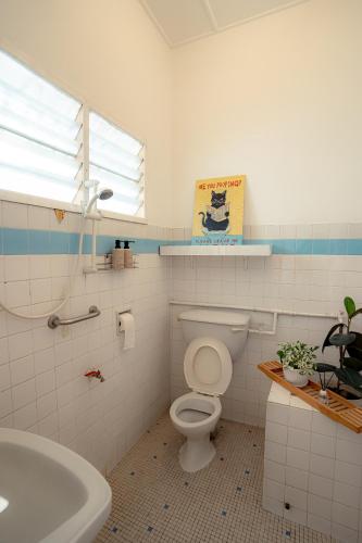 a bathroom with a white toilet and a sink at Tido Home, private queen room w bathroom, shared public area in Ipoh