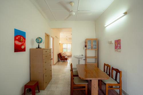 a room with a table and chairs and a dining room at Tido Home, private queen room w bathroom, shared public area in Ipoh