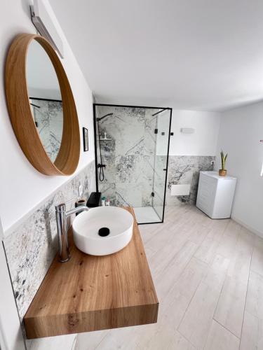 a bathroom with a white sink and a mirror at Gratitud Un refugio con encanto in Soo