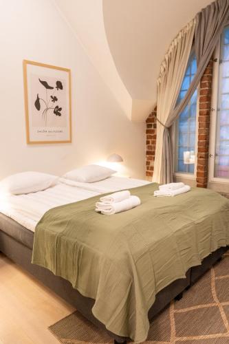 a bedroom with two beds and a window at Glorious penthouse with private sauna and jacuzzi in Helsinki