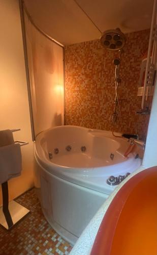 a bathroom with a large tub in a room at Grand Tour Suite Home in Spoleto
