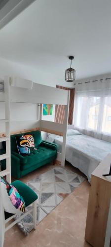 a bedroom with a bed and a green couch at Alojamiento céntrico Ribeira con parking sin ascensor in Ribeira