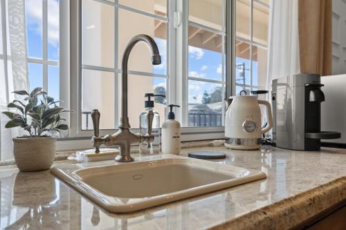 a kitchen counter with a sink in front of a window at Bella Notte by the Beach in Santa Cruz
