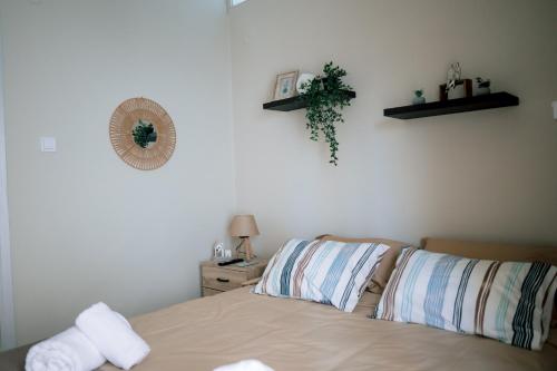 a bedroom with a bed with two pillows at Blue Horizon Corinth in Korinthos